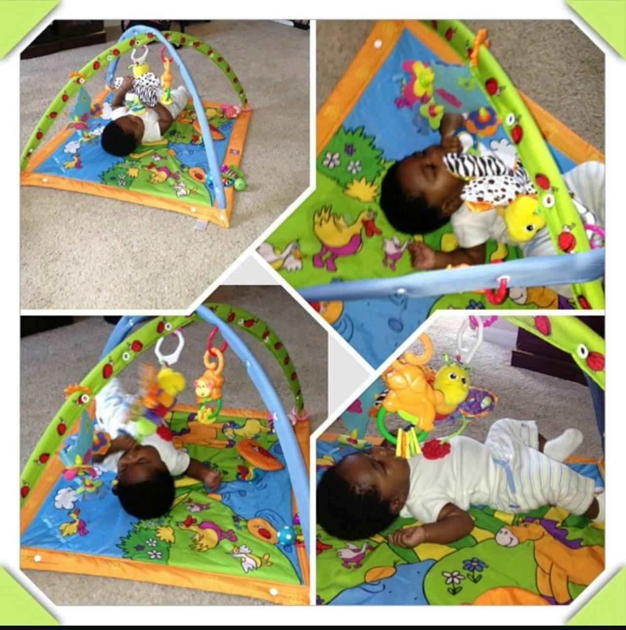 Child lying on a play mat with hanging toys