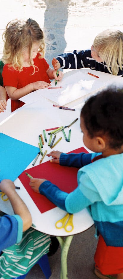 Children drawing and coloring at a table