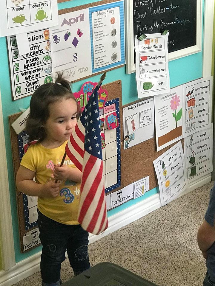 Child holding a small American flag