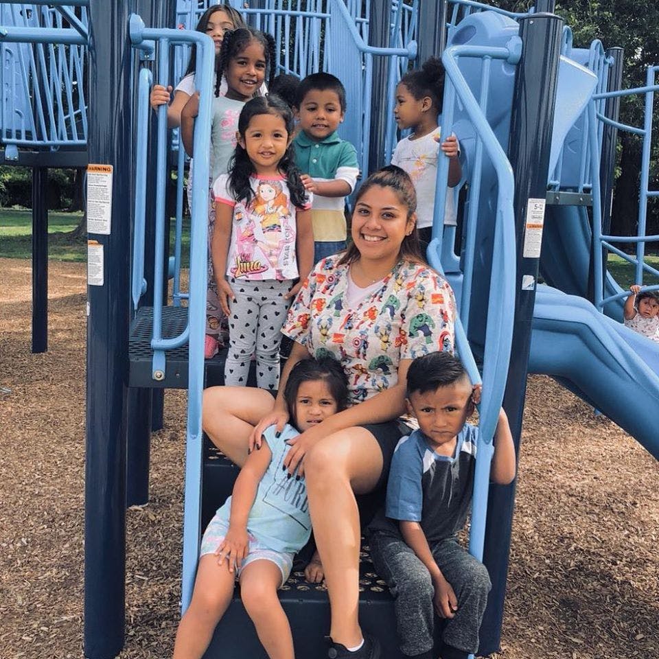 Person and multiple children on a playground structure