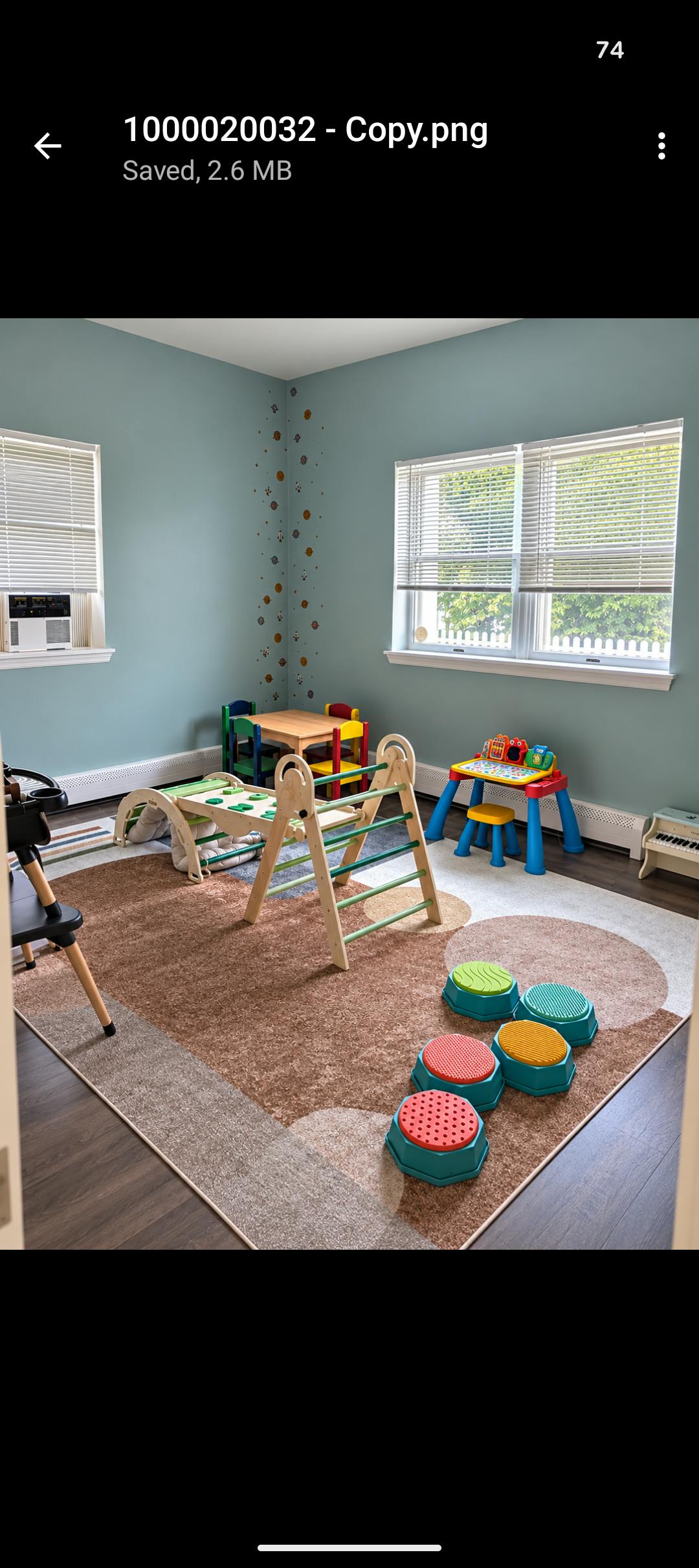Playroom with wooden climbing structure, balance stones, and child-sized furniture