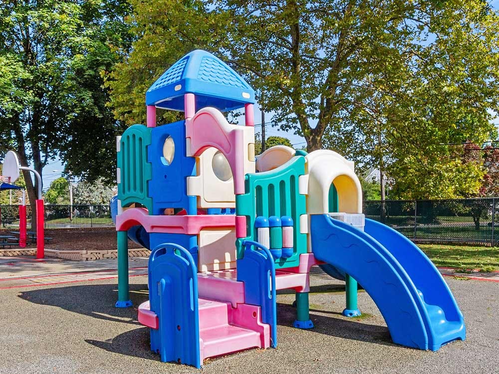 Colorful playground structure with slides and climbing areas