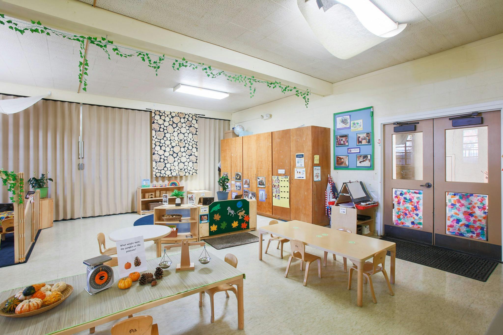 Empty classroom with small tables and chairs