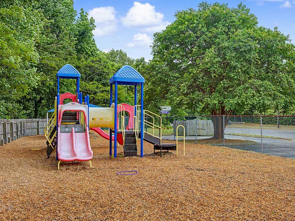 Playground with slides and climbing structure on a wood chip surface