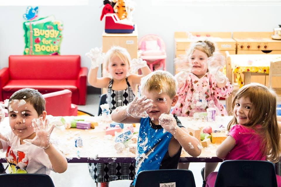 Children with messy faces and hands at a table