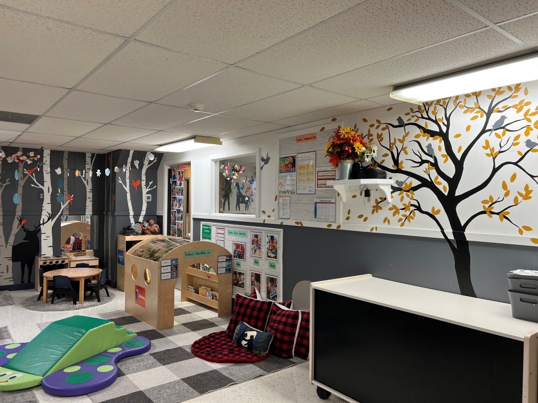 Children's classroom with nature-themed decor and play areas