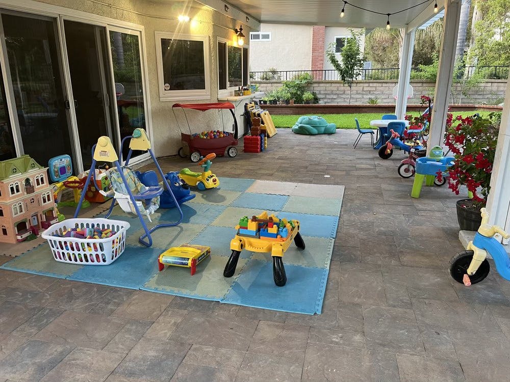 Outdoor patio with children's toys and play mats