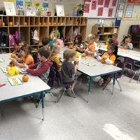 Children sitting at tables in a classroom