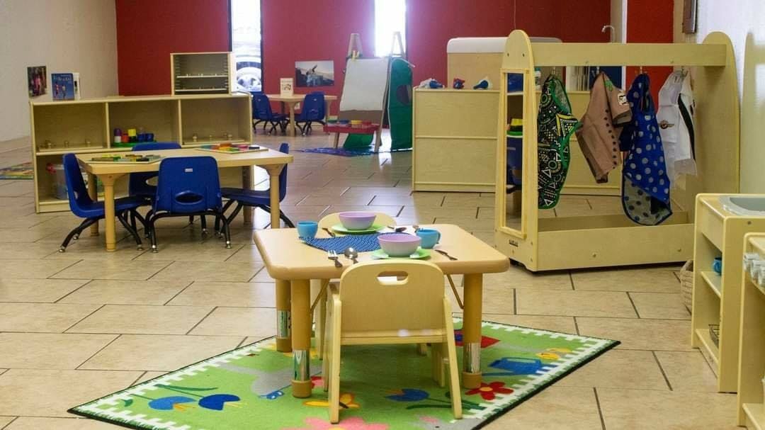 Empty classroom with small tables and chairs