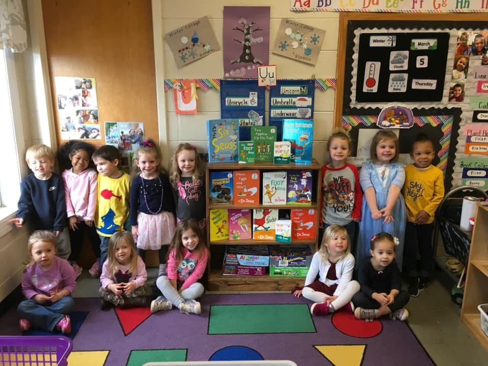 Group of children posing in a classroom