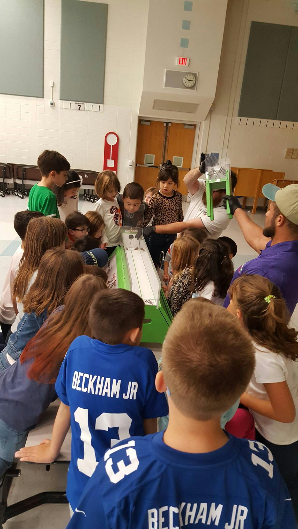 Adults and children gathered around a science experiment