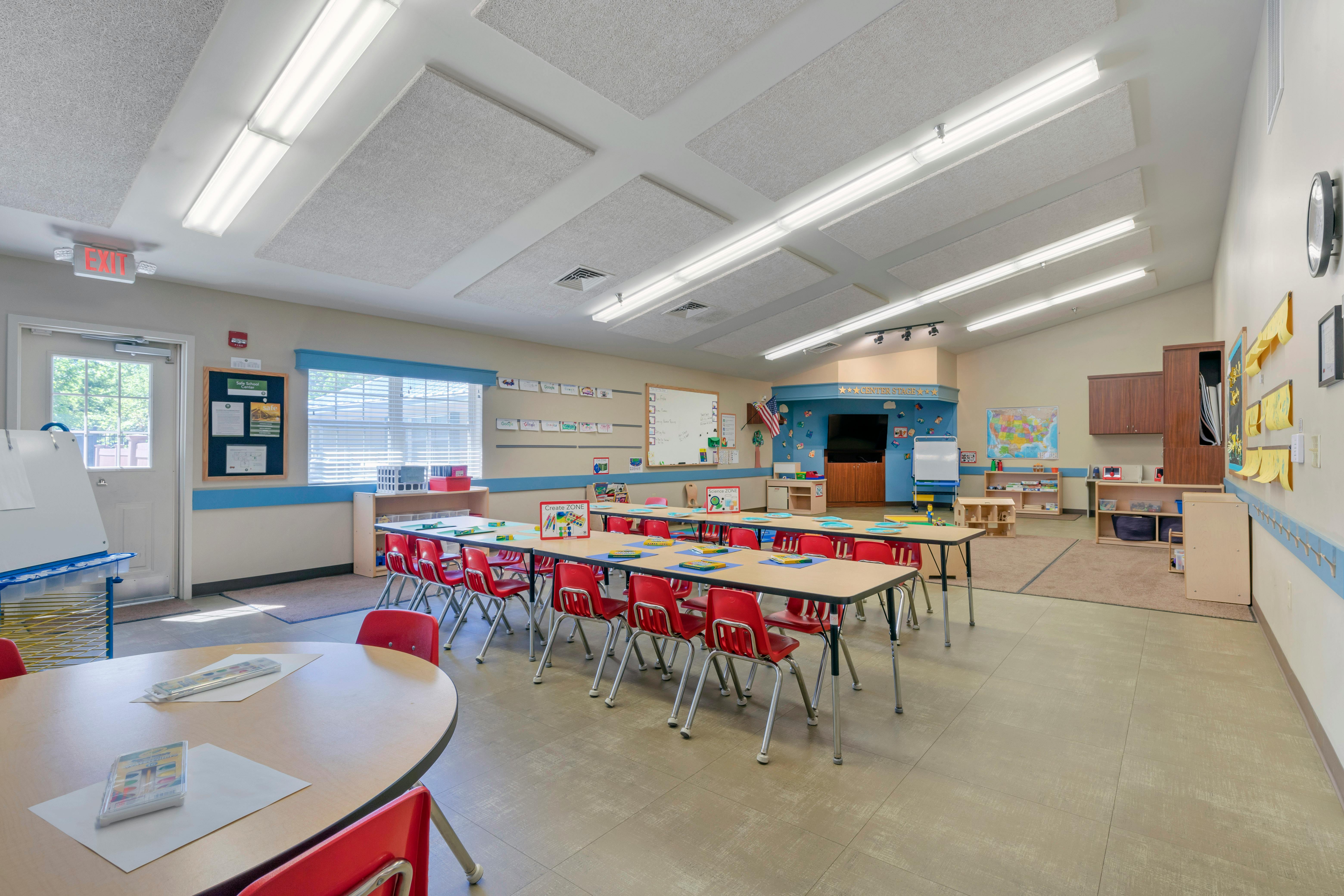Classroom with small red chairs and tables