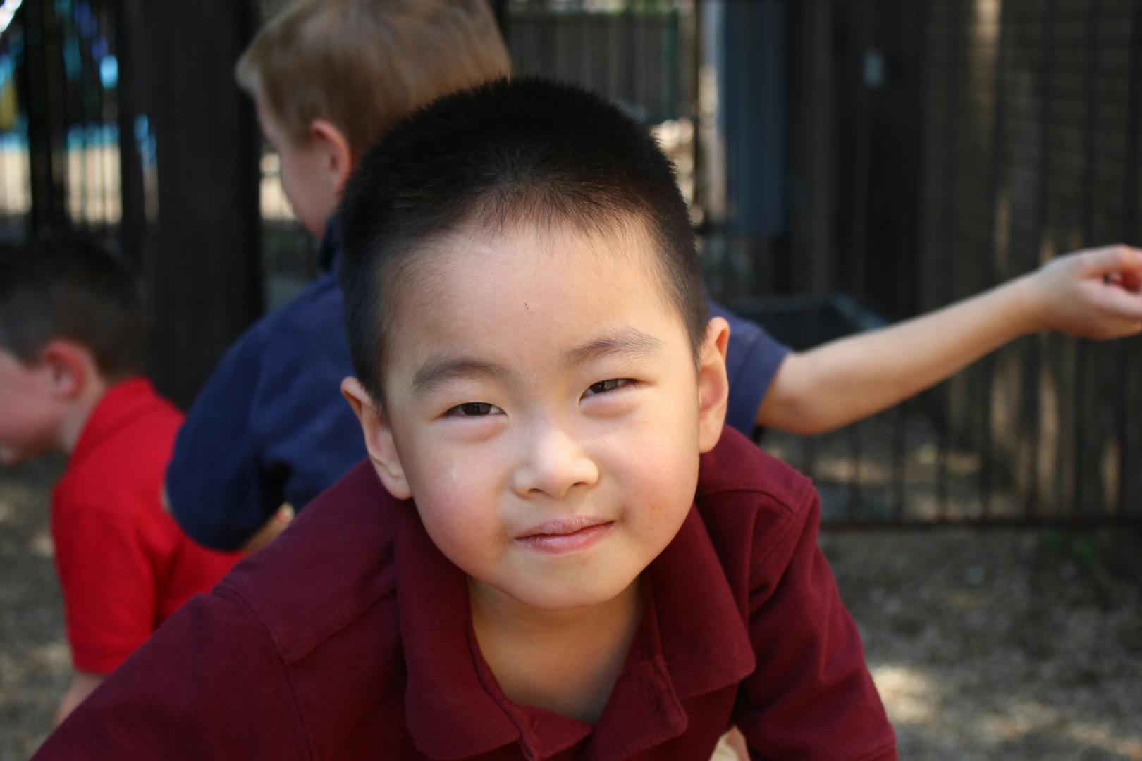 Child looking forward with other children in background