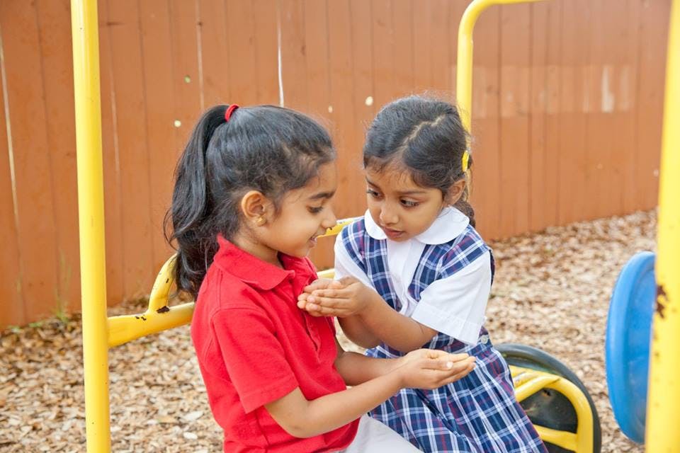 Two children interacting on a playground