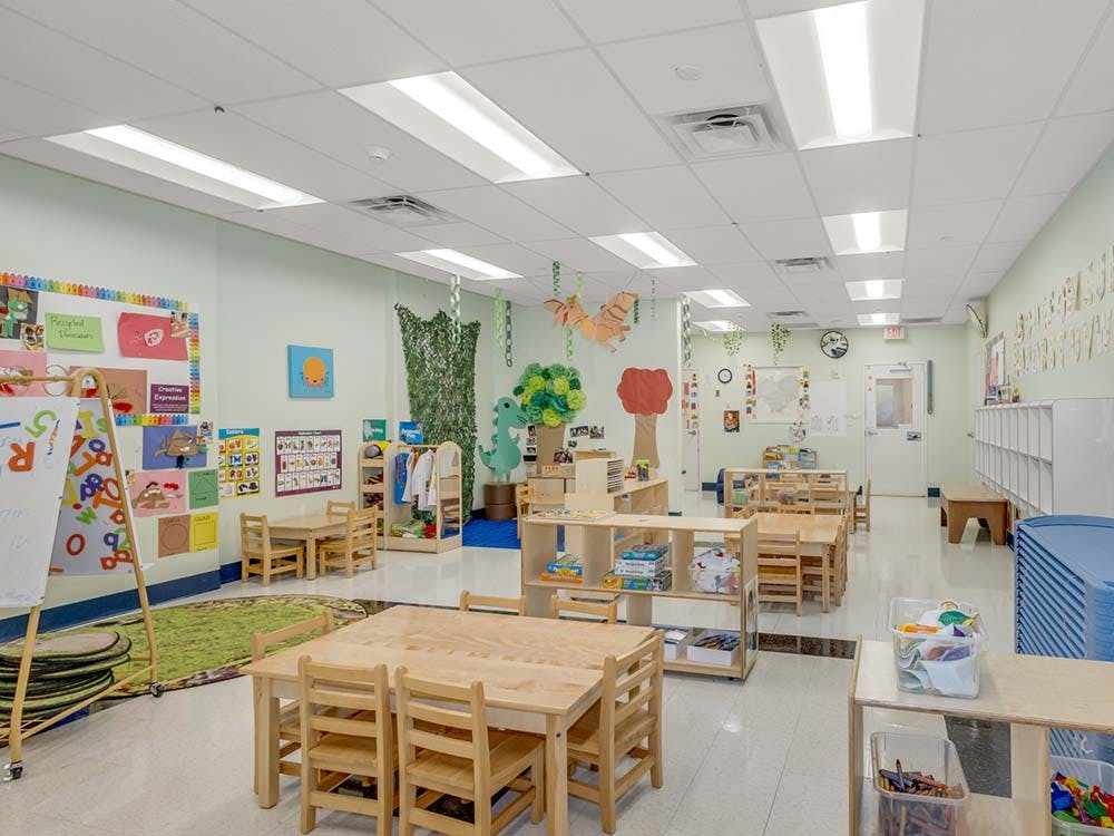 children's classroom with small wooden tables and chairs