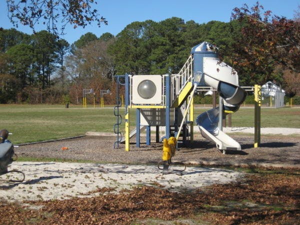 Playground structure with slides and climbing elements