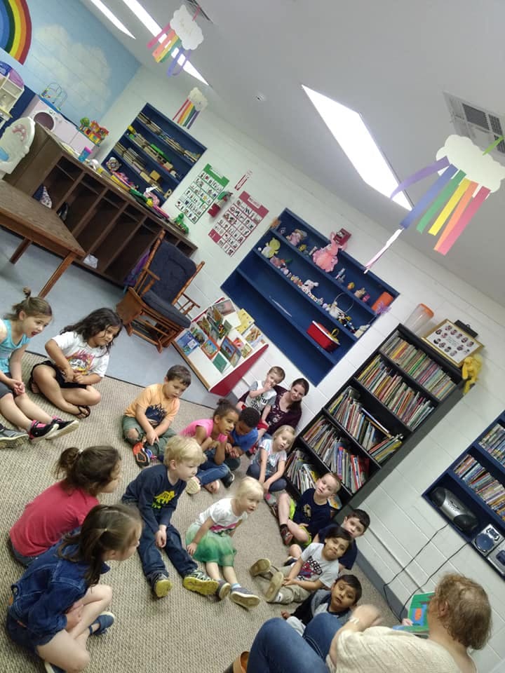 Children sitting on the floor in a classroom