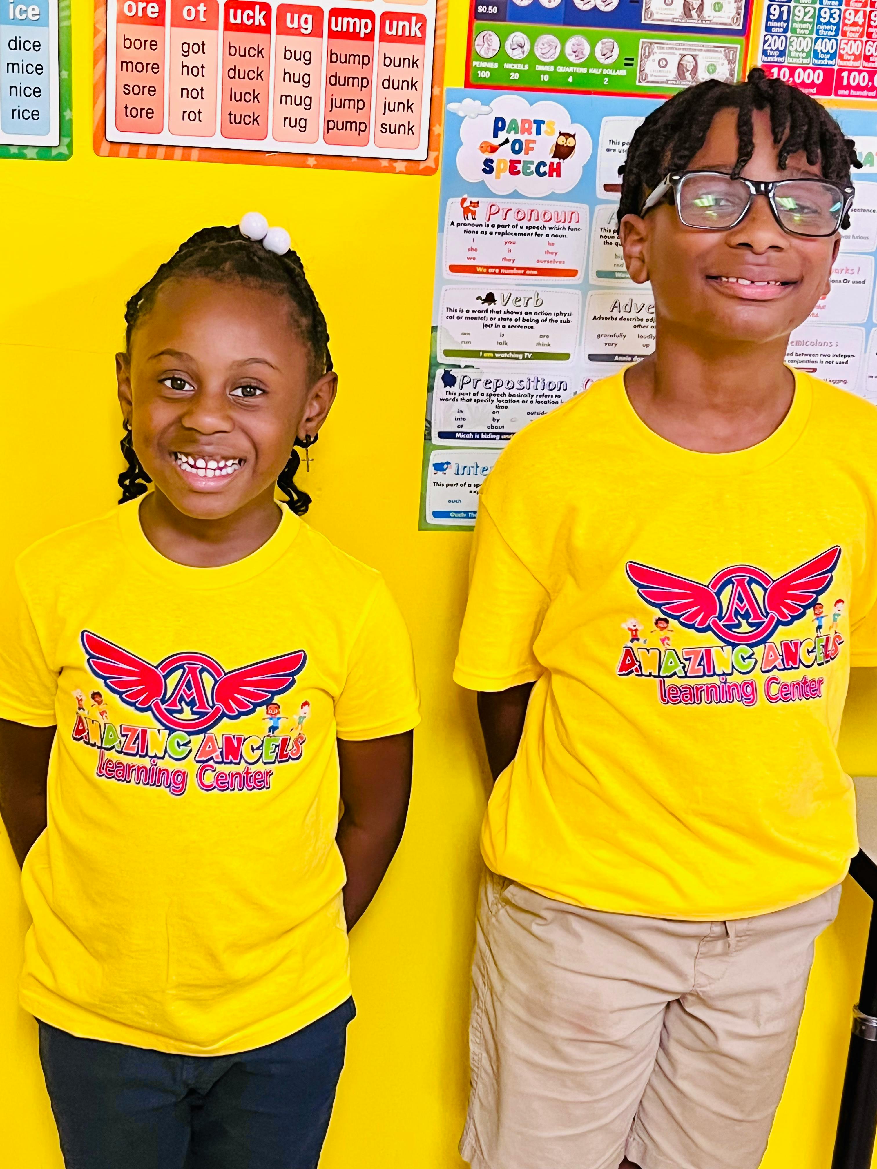 Two children in yellow shirts with "Amazing Angels Learning Center" logo