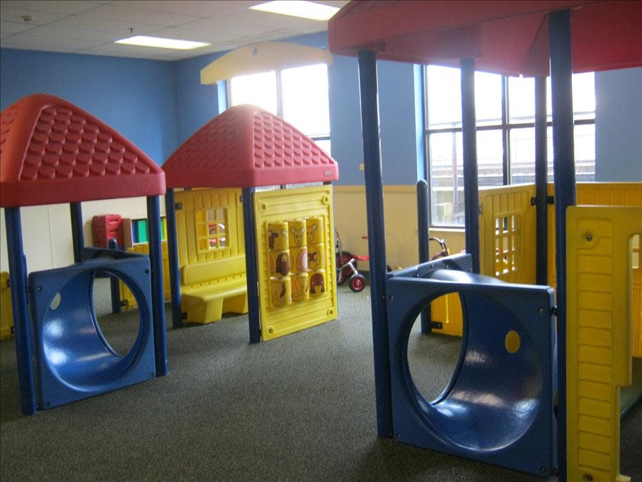 Colorful indoor playground structures with tunnels and windows