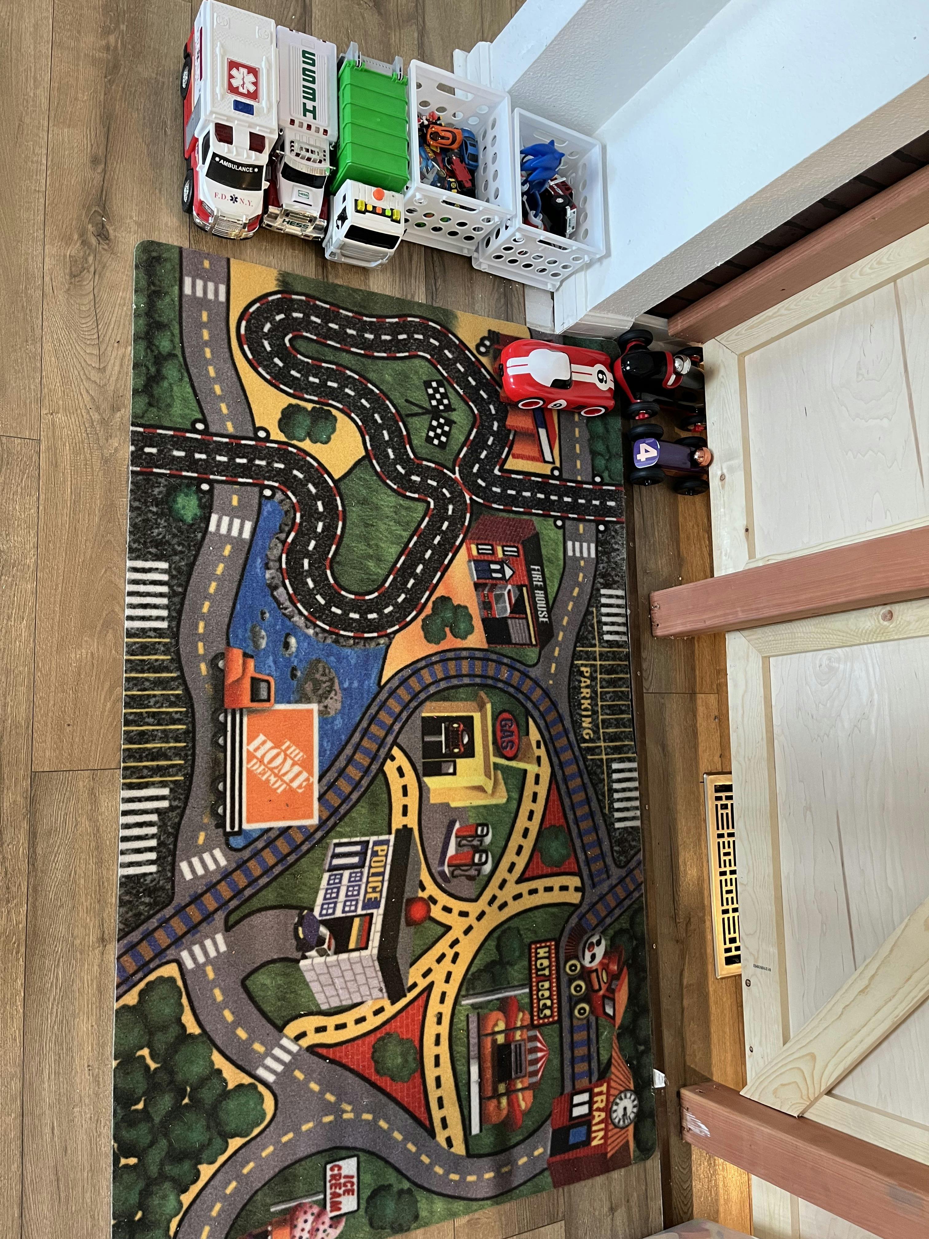 Ambulance, truck, and other toys on a playmat