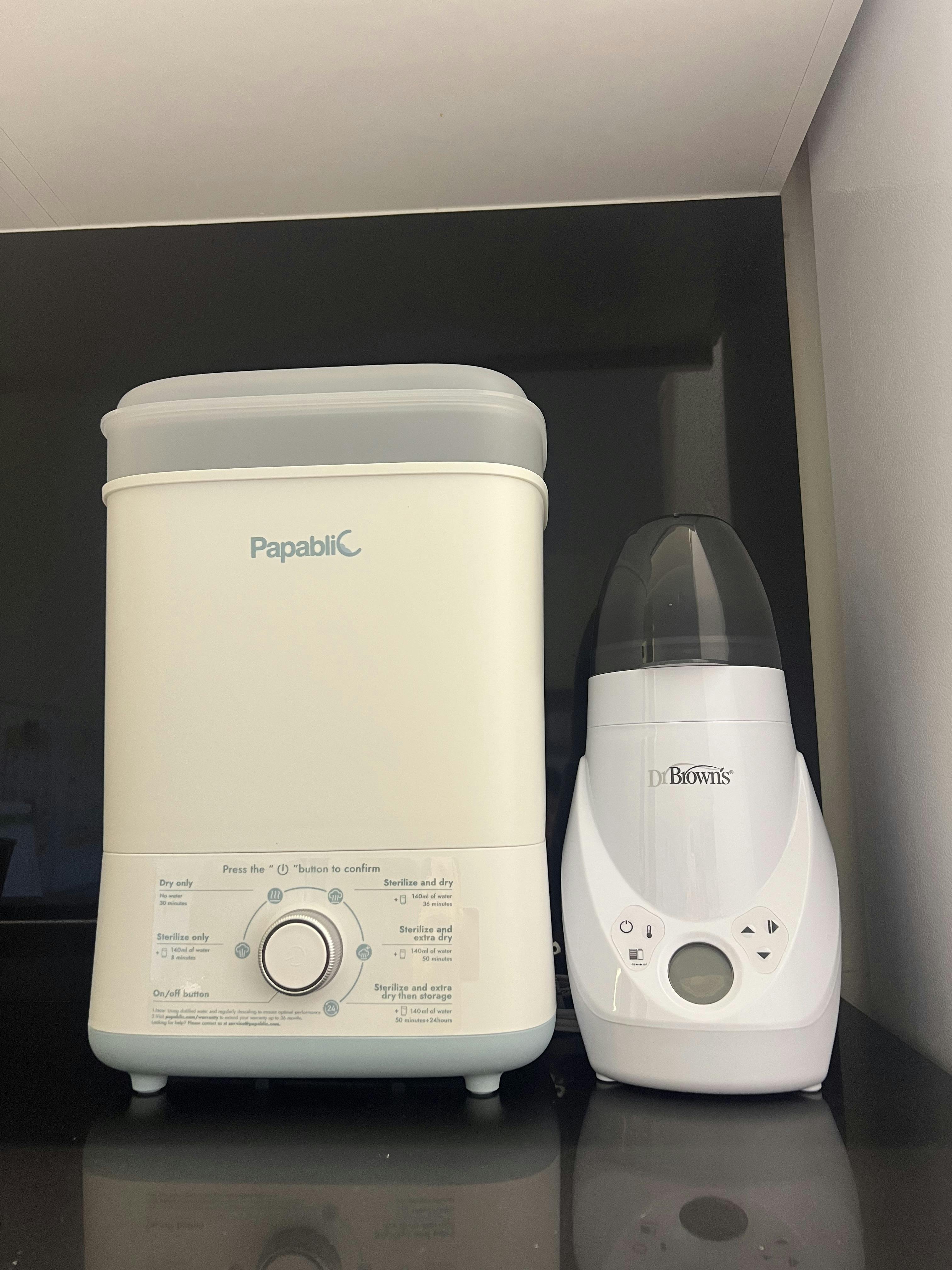 A Papablic sterilizer and a Dr. Brown's bottle warmer on a countertop