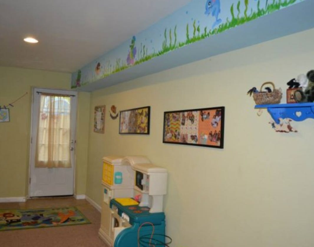 Playroom with toy kitchen set and wall decorations