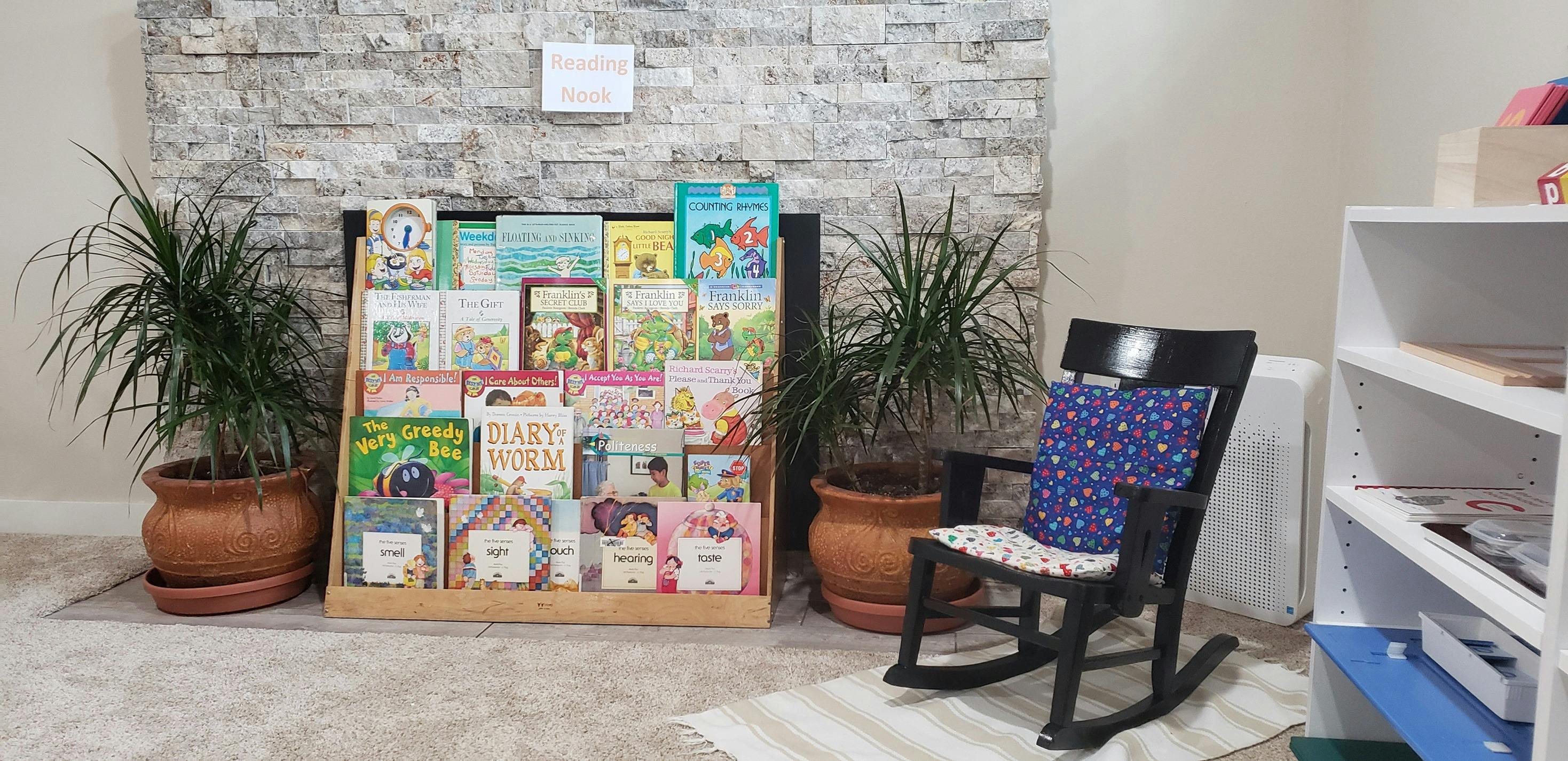 Book display with a rocking chair and potted plants