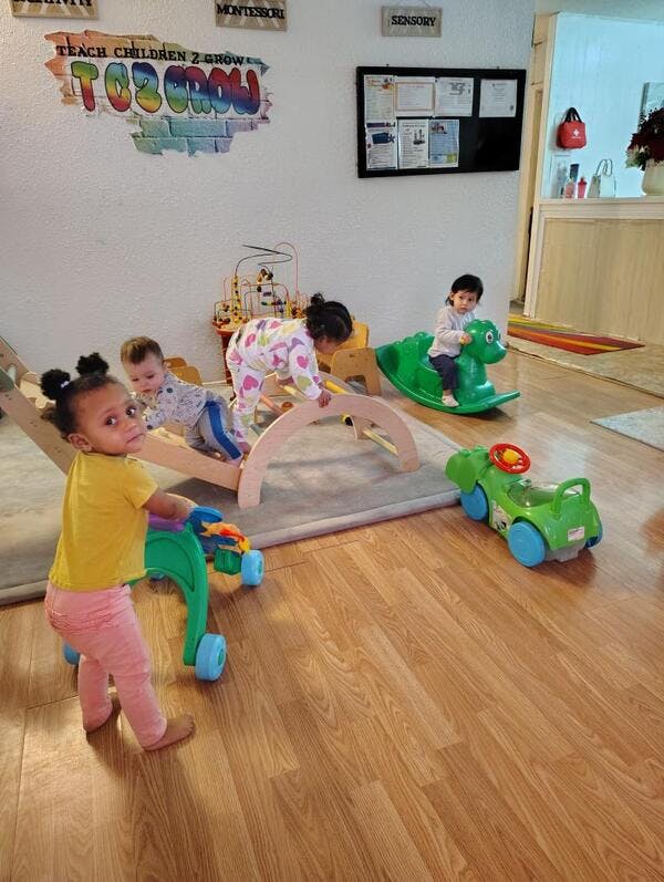 Several young children playing with toys in a room