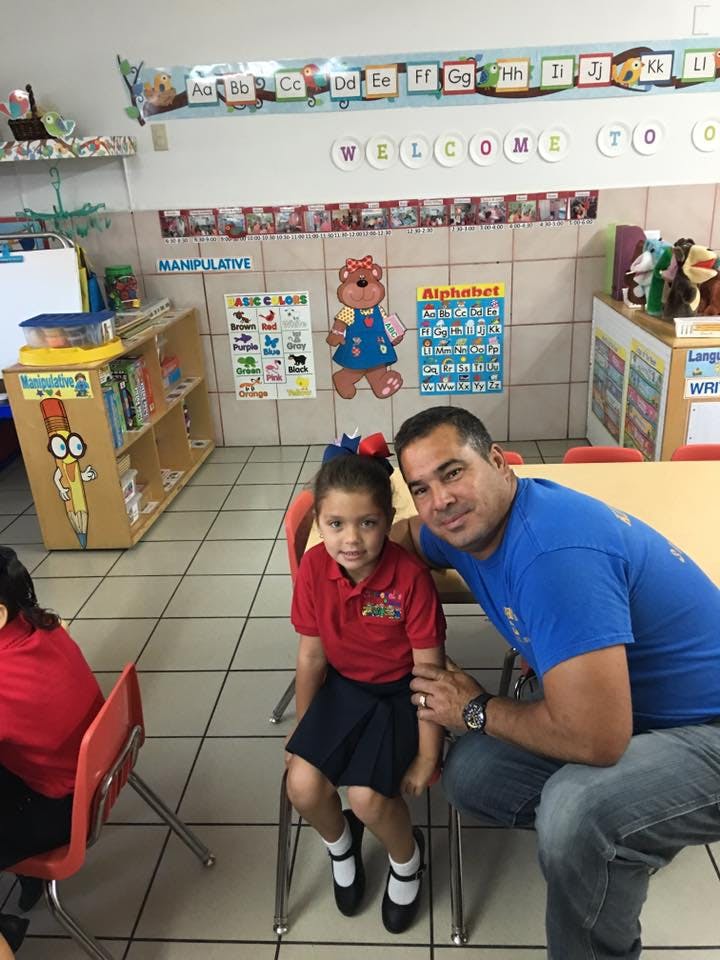 Adult and child sitting in a classroom