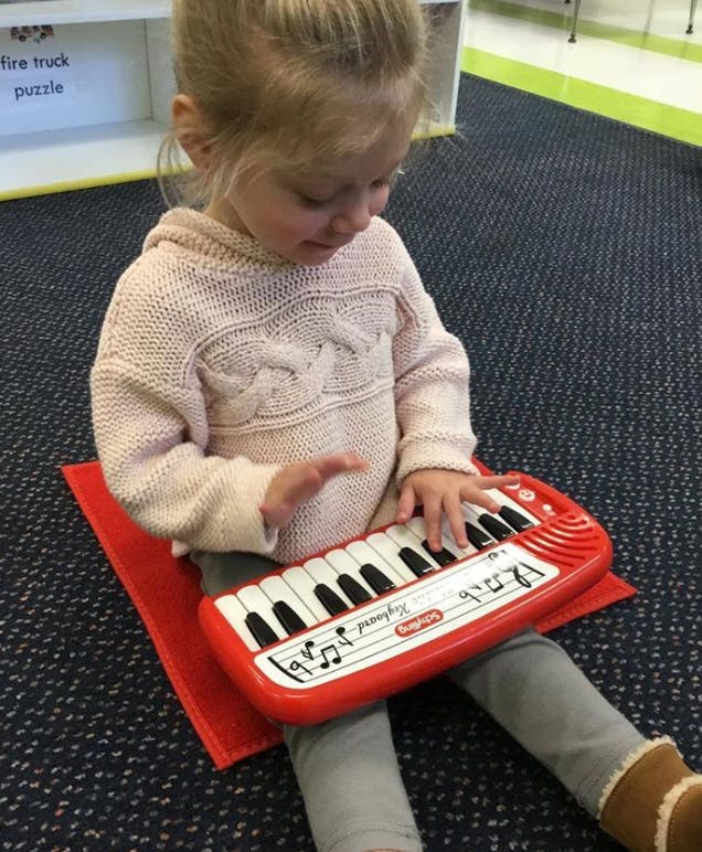 Child playing a toy keyboard