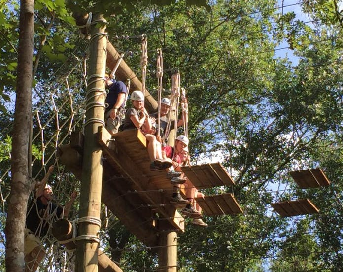 People on a high ropes course in trees