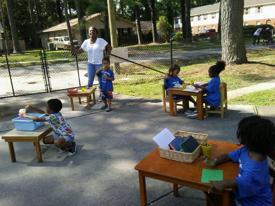 Adult and children engaged in outdoor activities