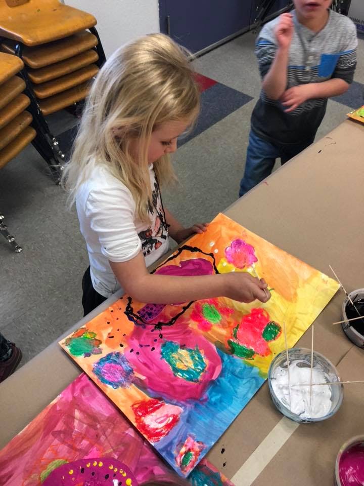Child painting a colorful abstract picture