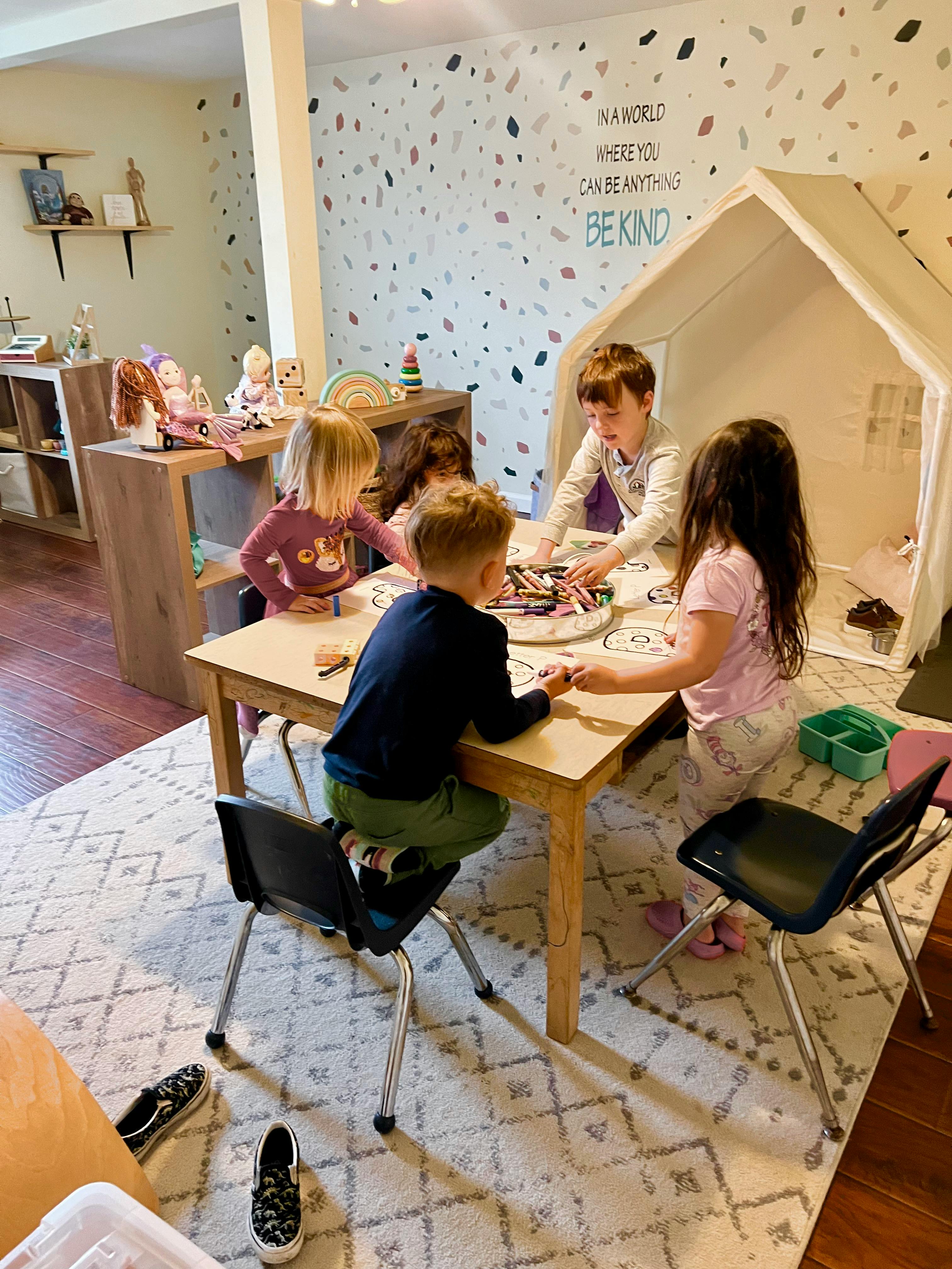 Children sitting at a table in a playroom