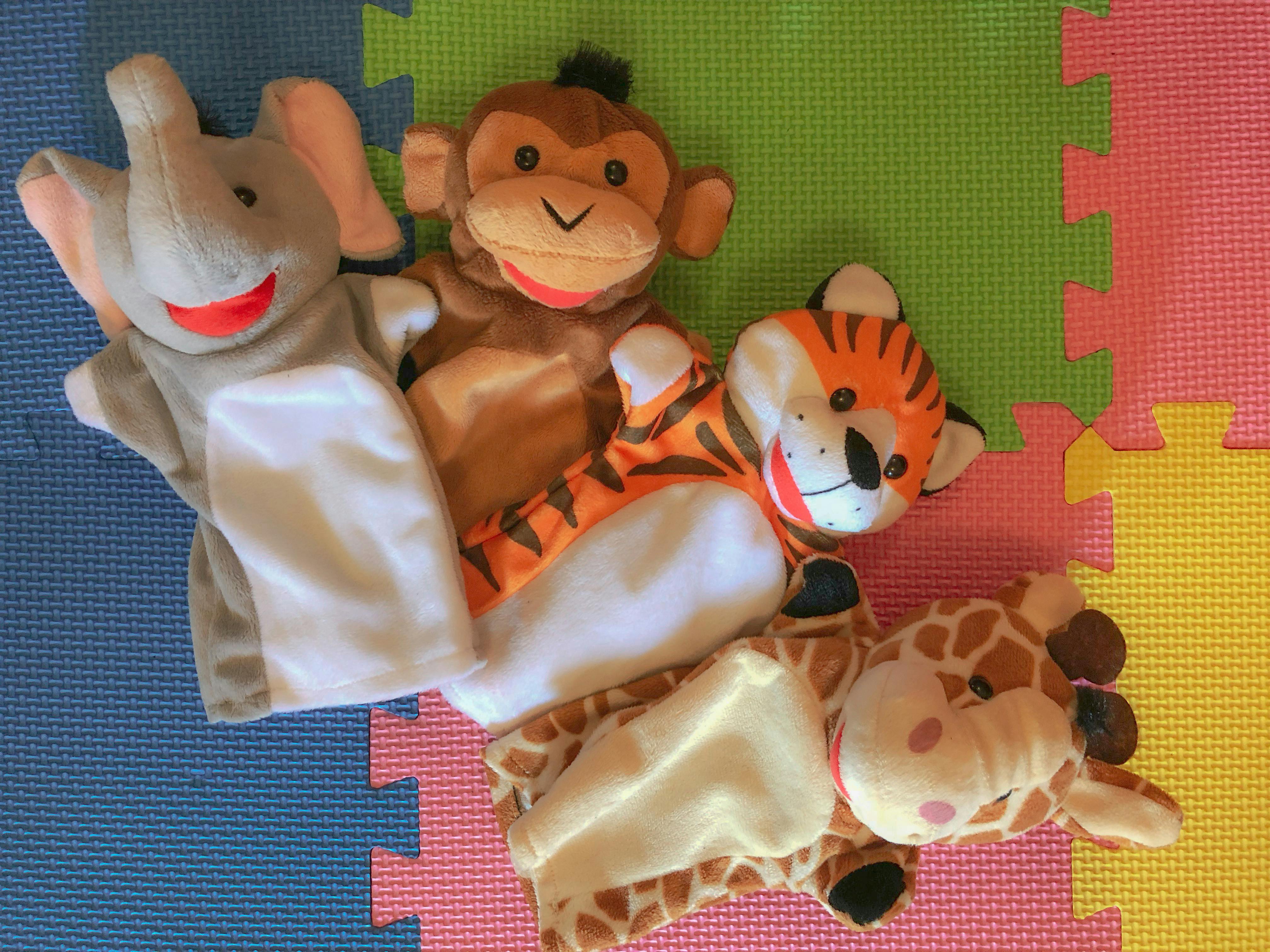 Four animal hand puppets, including an elephant, monkey, tiger, and giraffe