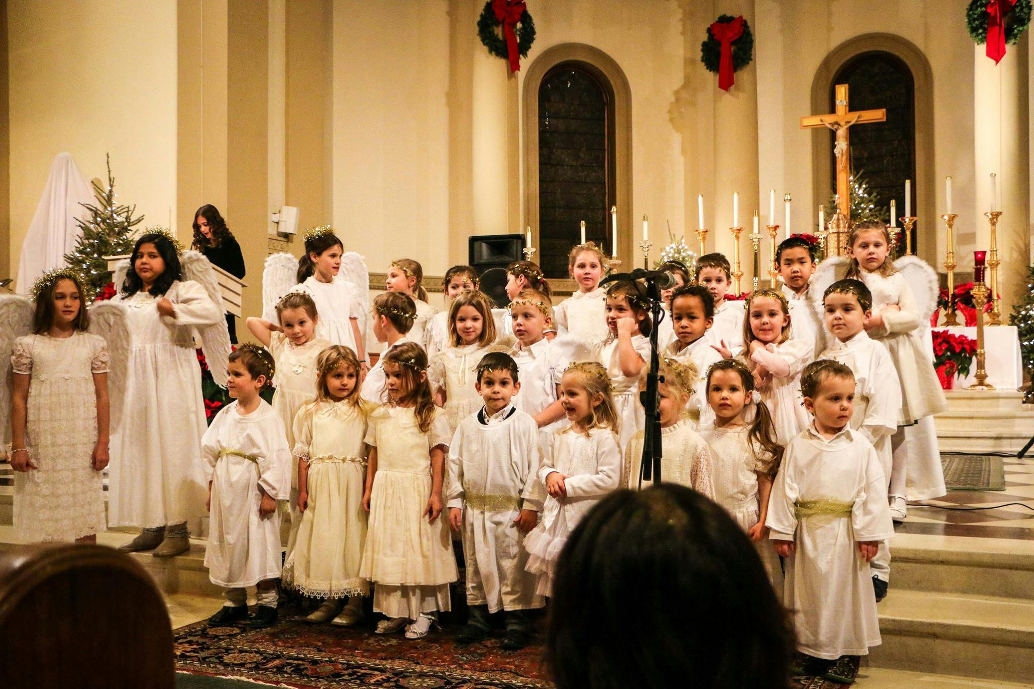 Children in white robes standing in a church