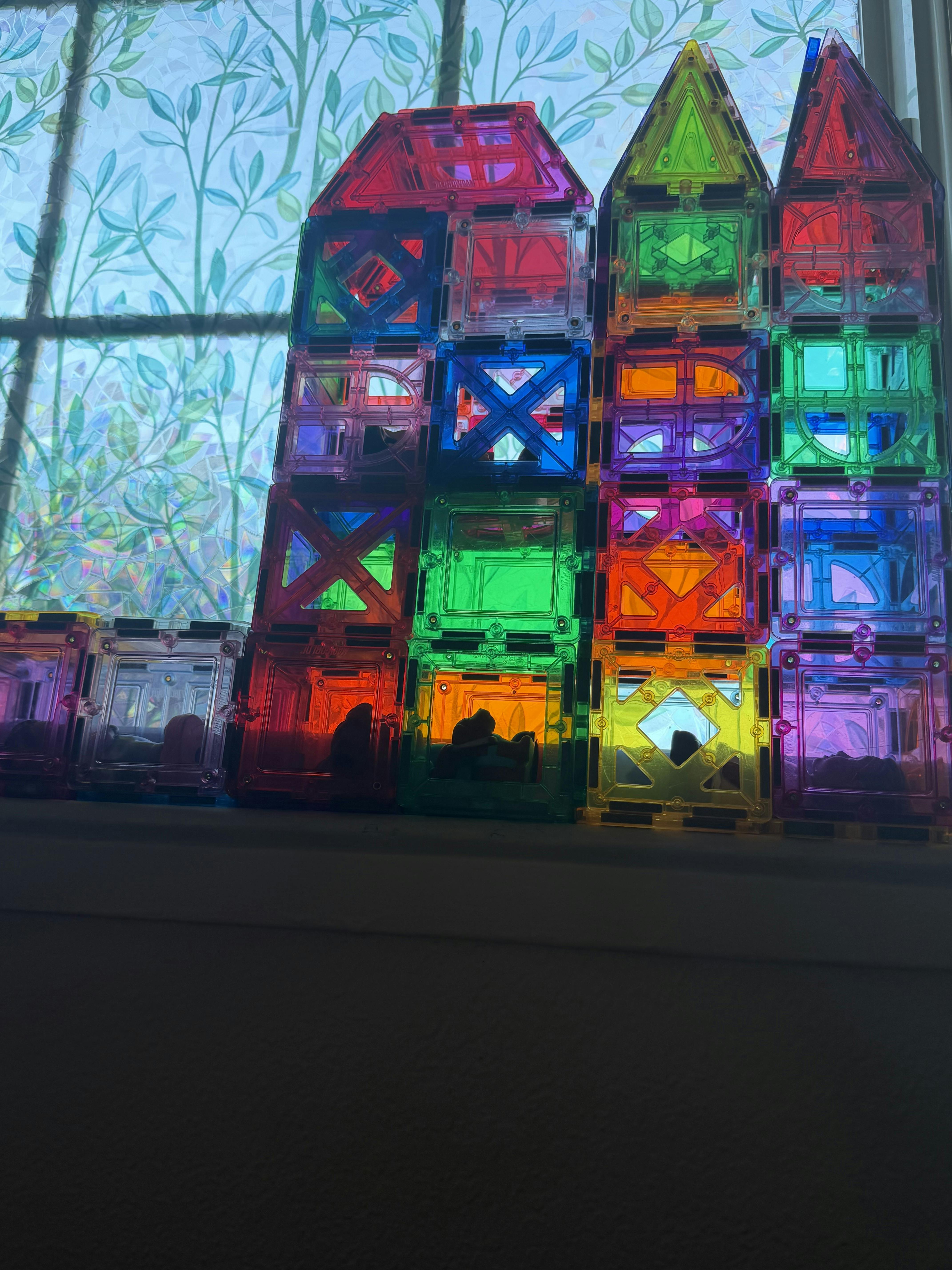Colorful magnetic tile houses built in front of a window