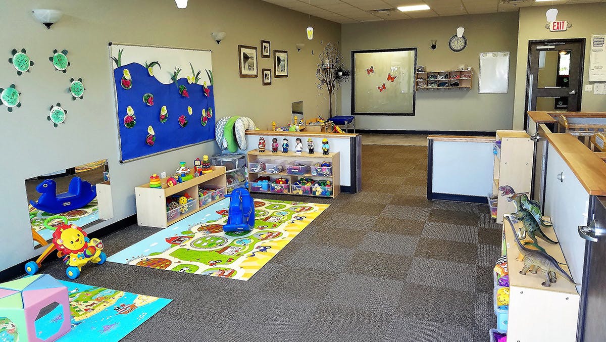 Playroom with colorful rugs, toys, and wall decorations