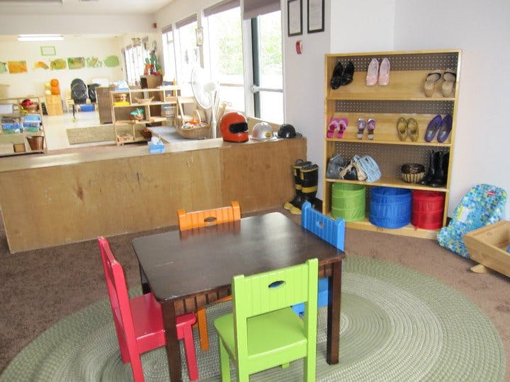 Children's classroom with small table and chairs, and shoe rack