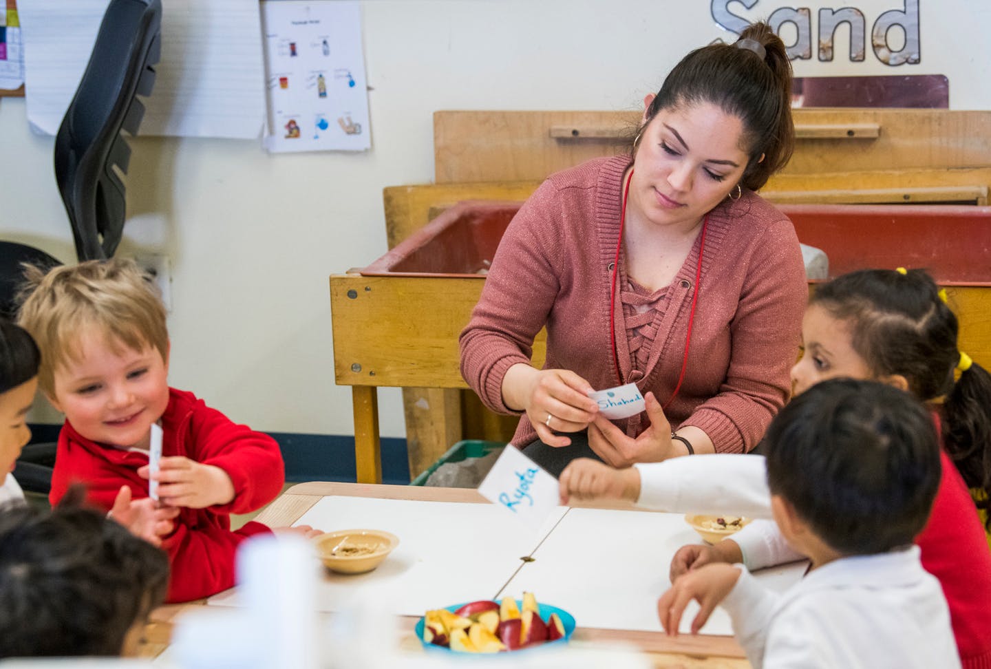 Adult and children at a table in a classroom