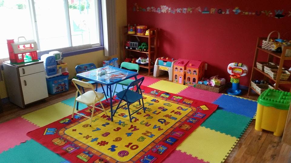 Playroom with small table and chairs on a colorful alphabet rug