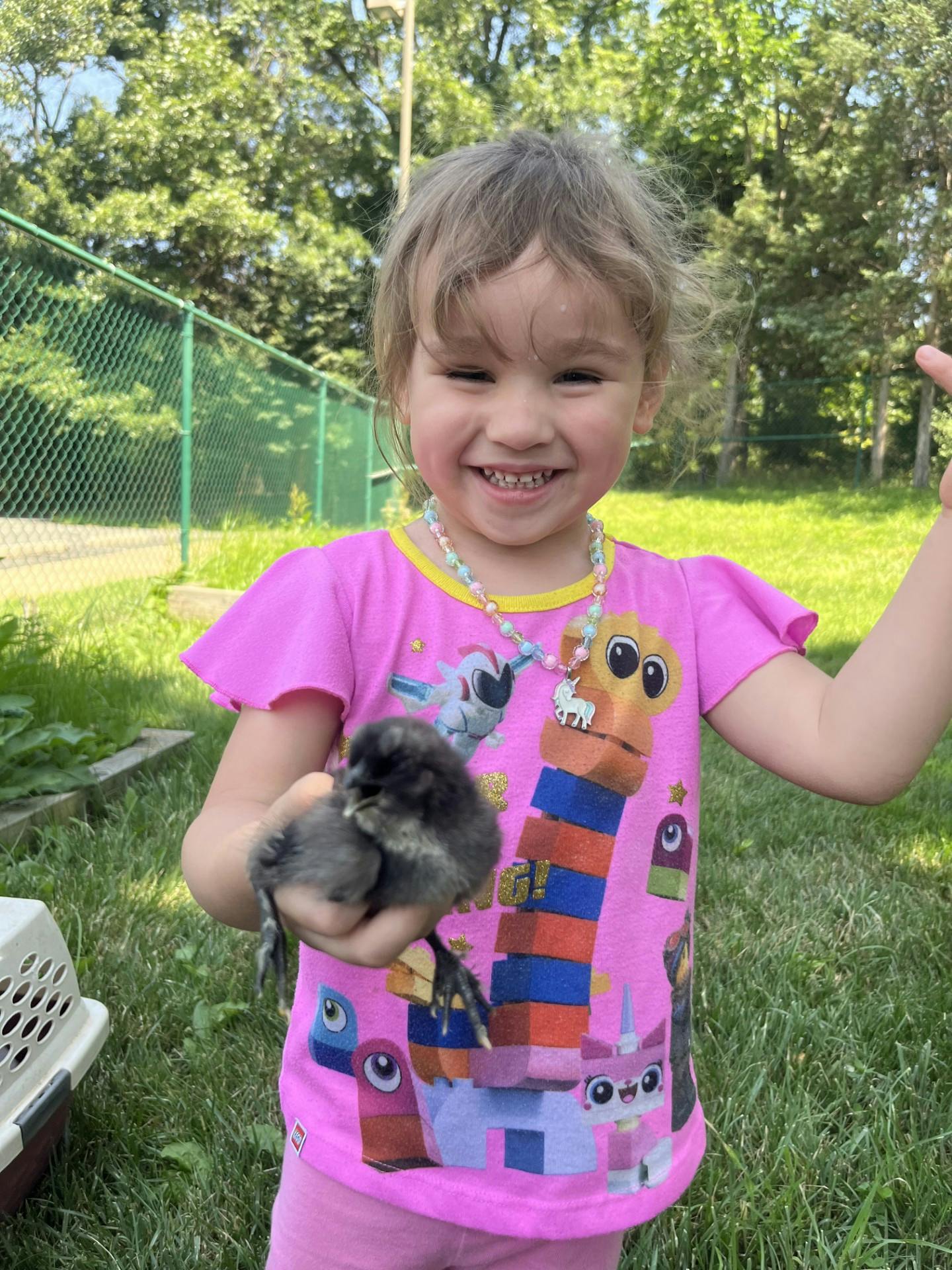 Child holding a small chick