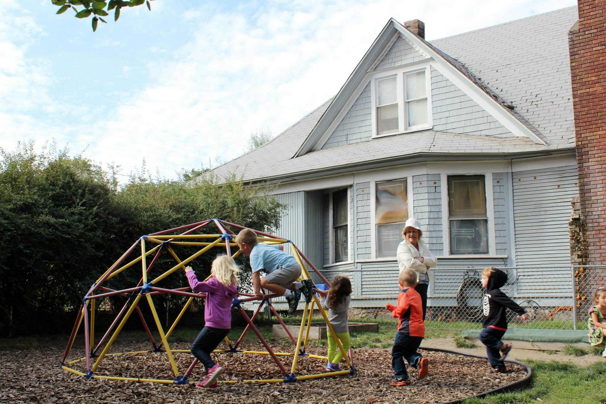Children playing on a geometric dome climber on a playground
