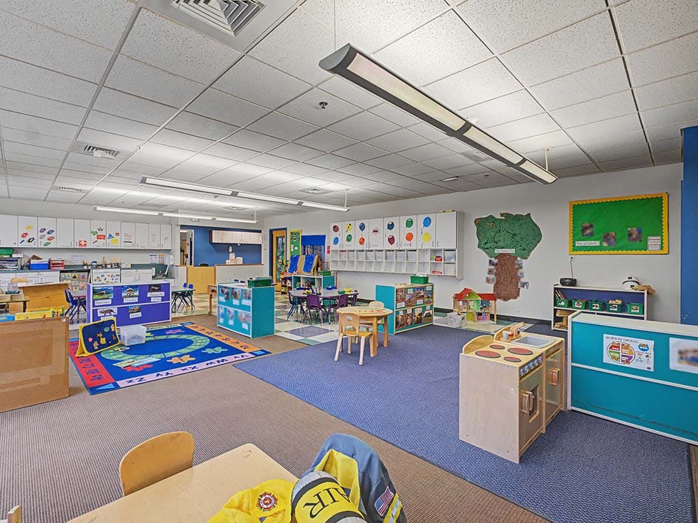 Colorful and organized preschool classroom with various play areas