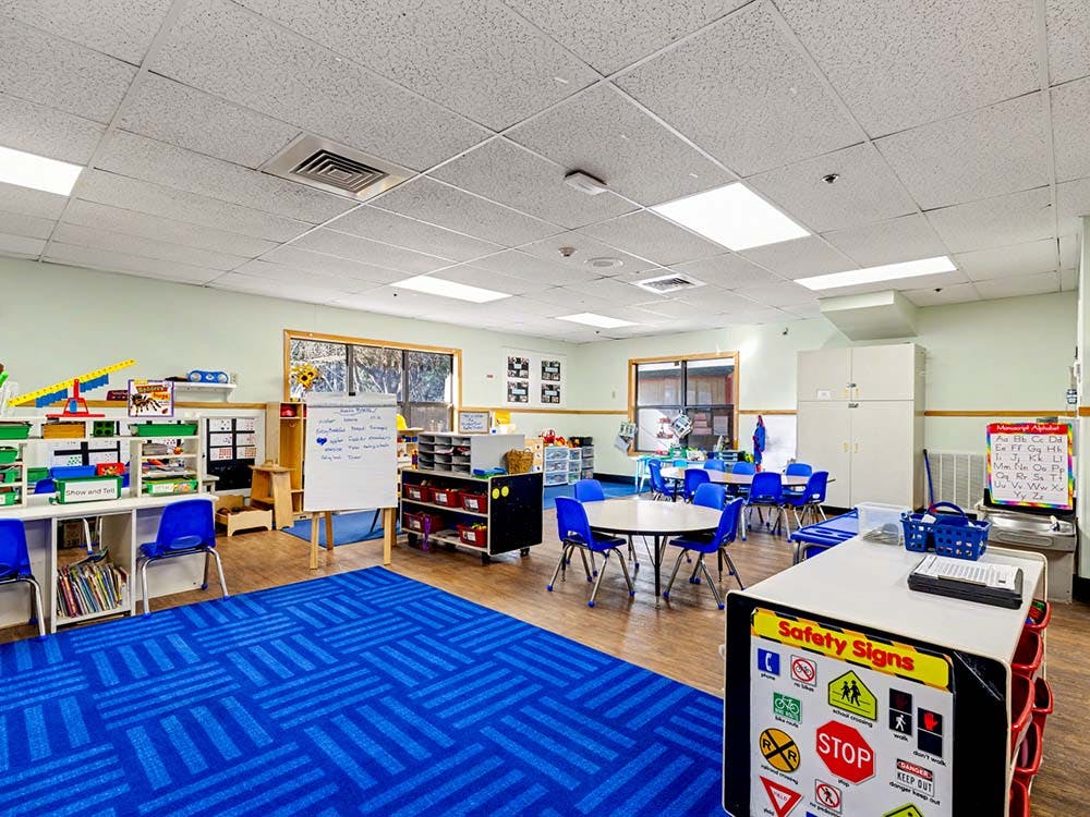 Classroom with tables, chairs, and learning materials