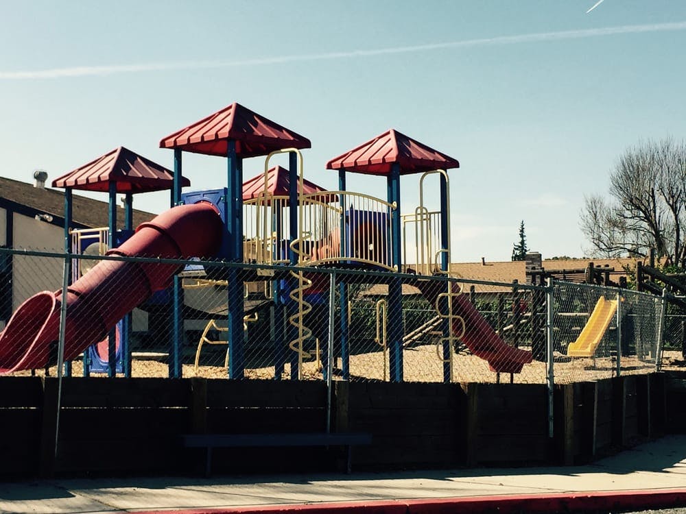 Playground with red slides and red canopies