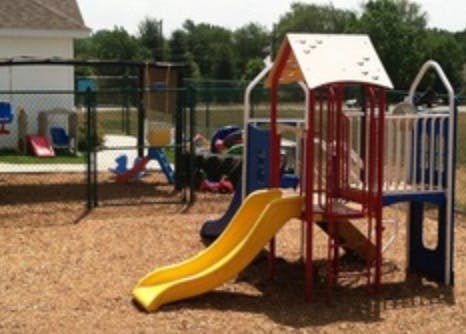 Playground with yellow slide and climbing structure