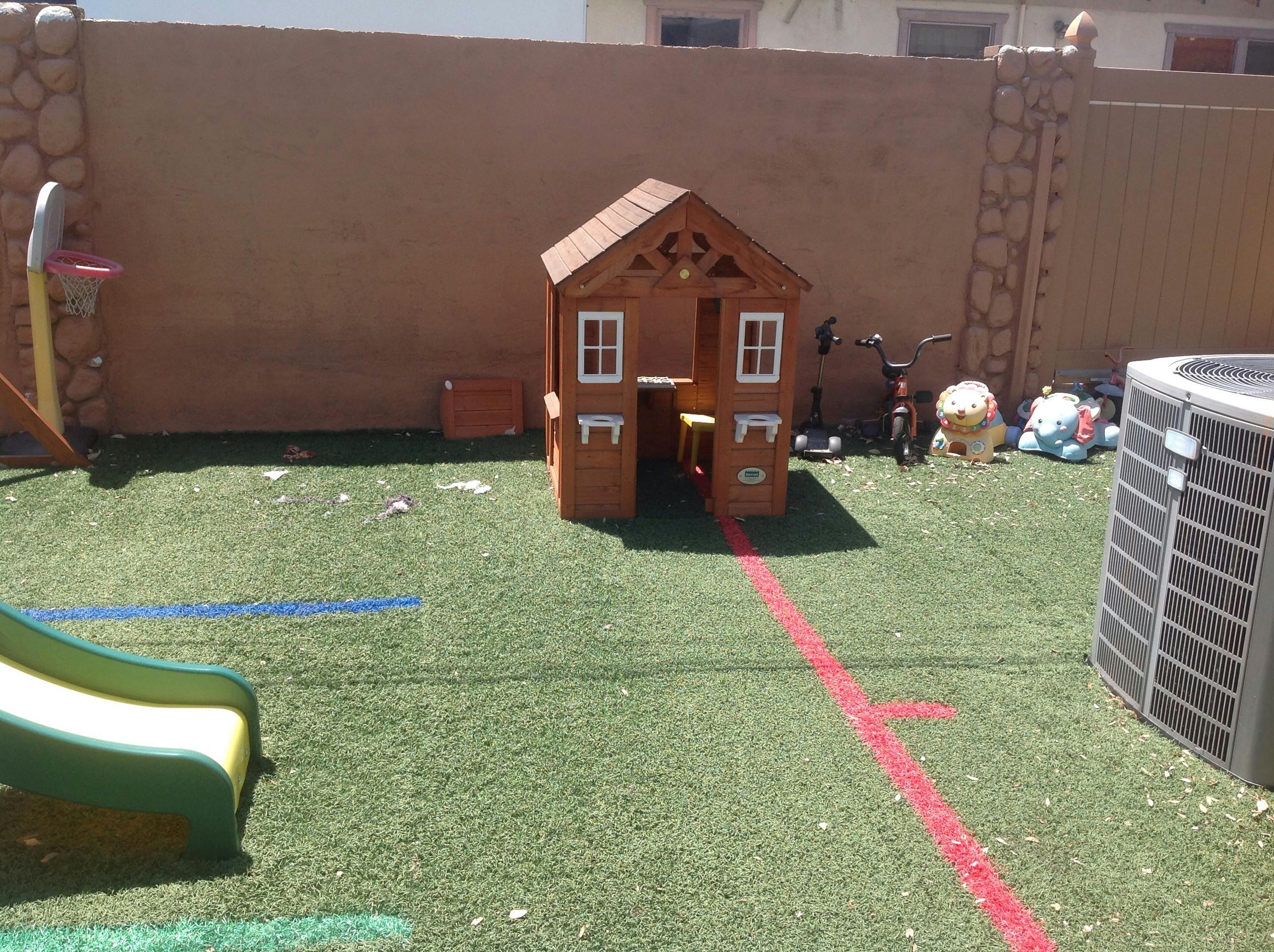 Playhouse and slide on artificial grass