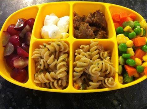 Yellow divided plate with grapes, cheese, ground meat, pasta, and mixed vegetables