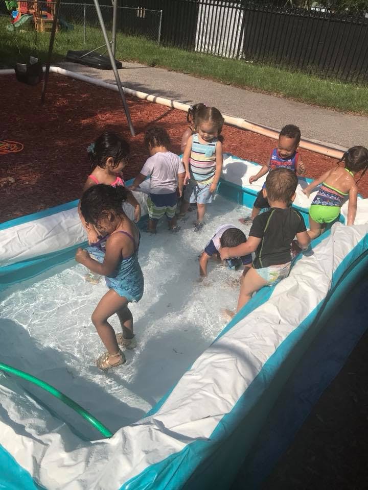 Children playing in an inflatable pool